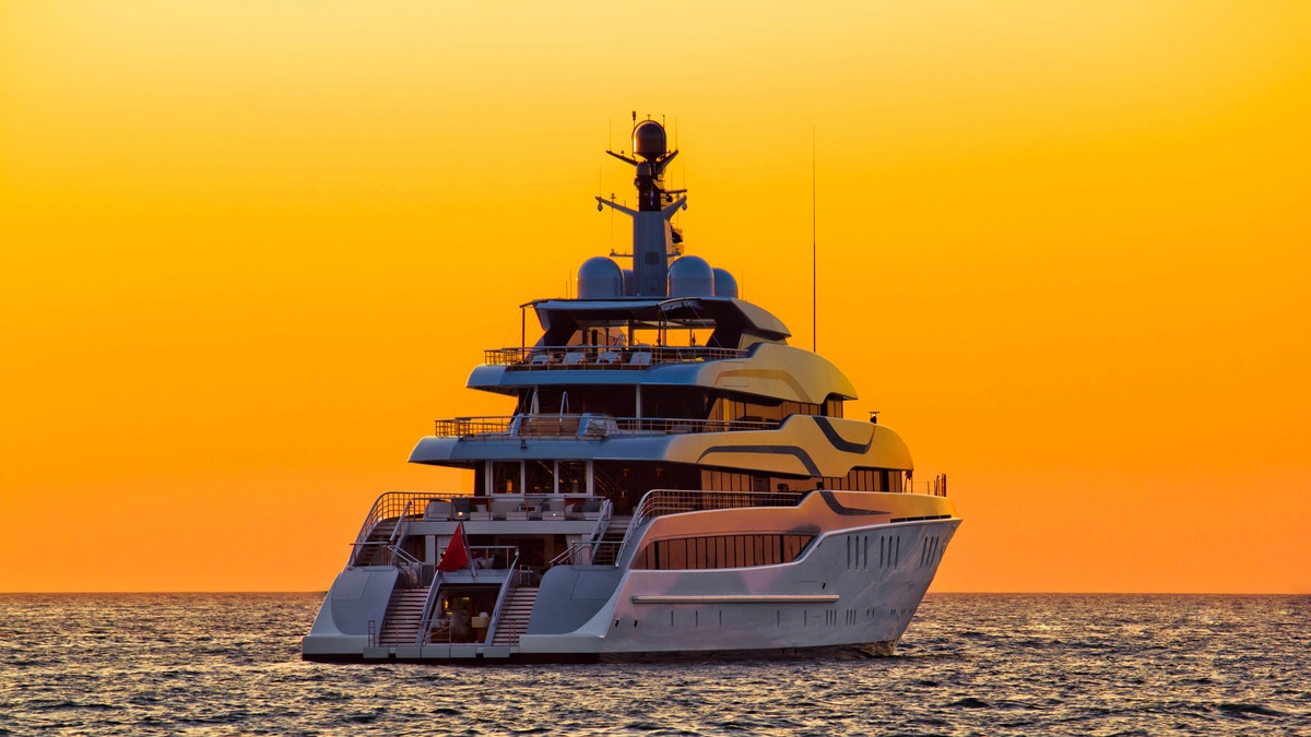 Luxury yacht on open sea at sunset