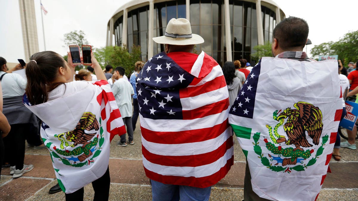 FILE - In this June 26, 2017, file photo, protesters outside the federal courthouse in San Antonio, Texas, take part in a rally to oppose a new Texas 