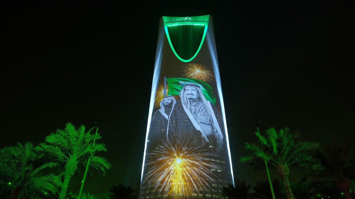 FILE - In this file photo taken onIn this Sunday, Sept. 24, 2017 photo released by the Saudi Culture and Information Ministry, the image of King Salman and Crown Prince Mohammed bin Salman are projected on the Kingdom Tower during National Day ceremonies in Riyadh, Saudi Arabia. . Saudi Arabia announced on Monday, Dec. 11, 2017 it will allow movie theaters to open in the conservative kingdom next year, for the first time in more than 35 years, in the latest social push by the countryââ¬â¢s young crown prince. (Saudi Culture and Information Ministry via AP, File)
