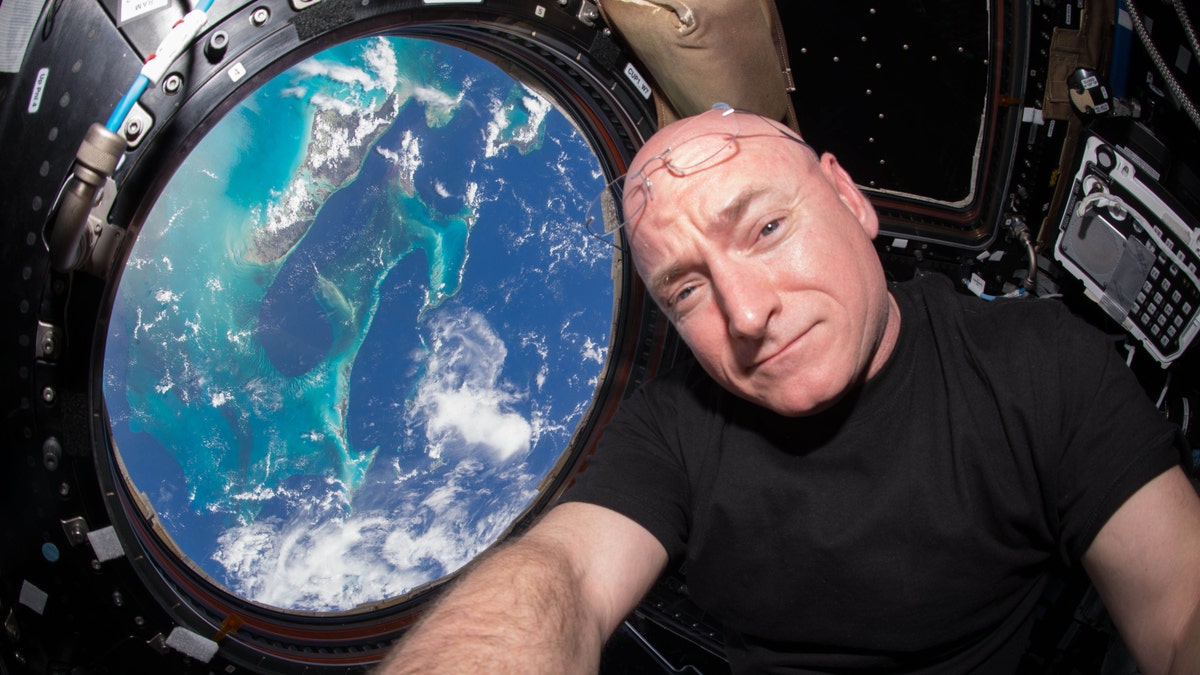 CORRECTS NUMBER OF DAYS TO 383, NOT 382 - This July 12, 2015 photo made available by NASA, astronaut Scott Kelly poses for a selfie photo in the 
