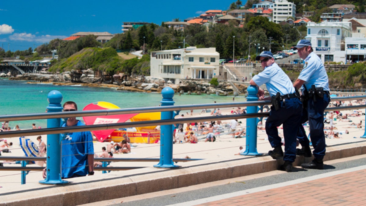 Two police officers watch the beach at Coogee, Sydney