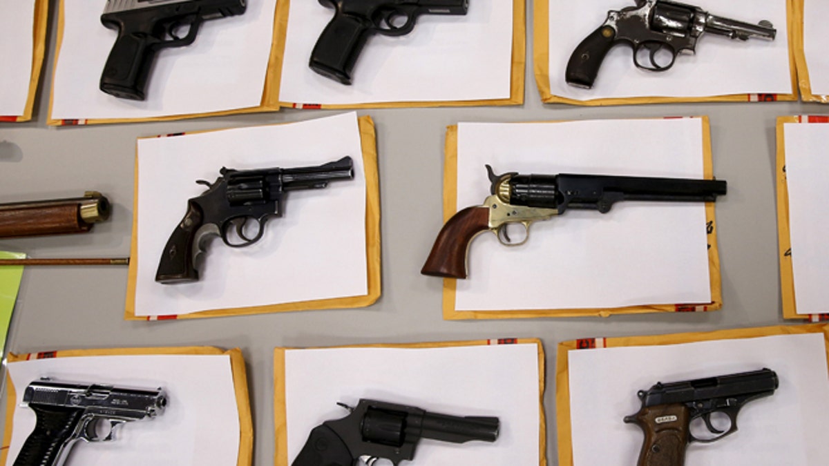 Some of the guns seized over the last week are seen on display at the Chicago Police Department in Chicago, Illinois, United States, August 31, 2015. REUTERS/Jim Young - RTX1QHK9
