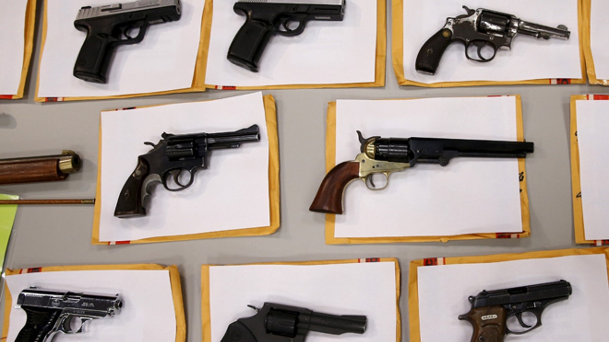 Some of the guns seized over the last week are seen on display at the Chicago Police Department in Chicago, Illinois, United States, August 31, 2015. REUTERS/Jim Young - RTX1QHK9