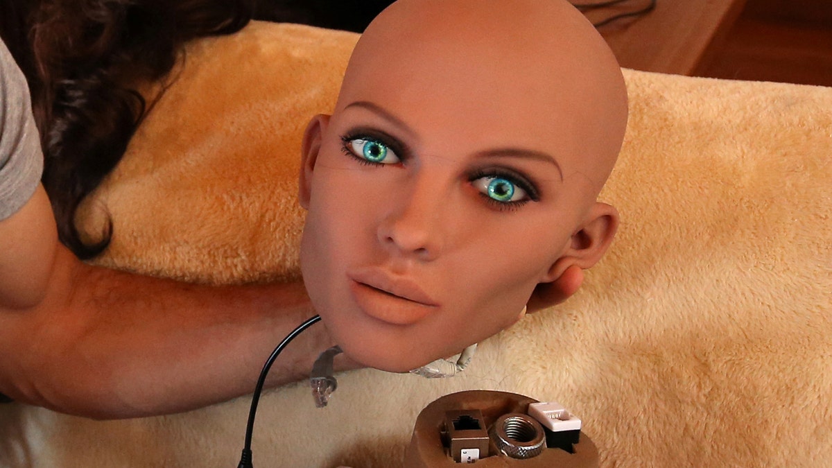 Catalan nanotechnology engineer Sergi Santos holds the head of Samantha, a sex doll packed with artificial intelligence providing her the capability to respond to different scenarios and verbal stimulus, in his house in Rubi, north of Barcelona, Spain, March 31, 2017. Picture taken March 31, 2017. REUTERS/Albert Gea - RC1C6A29B010
