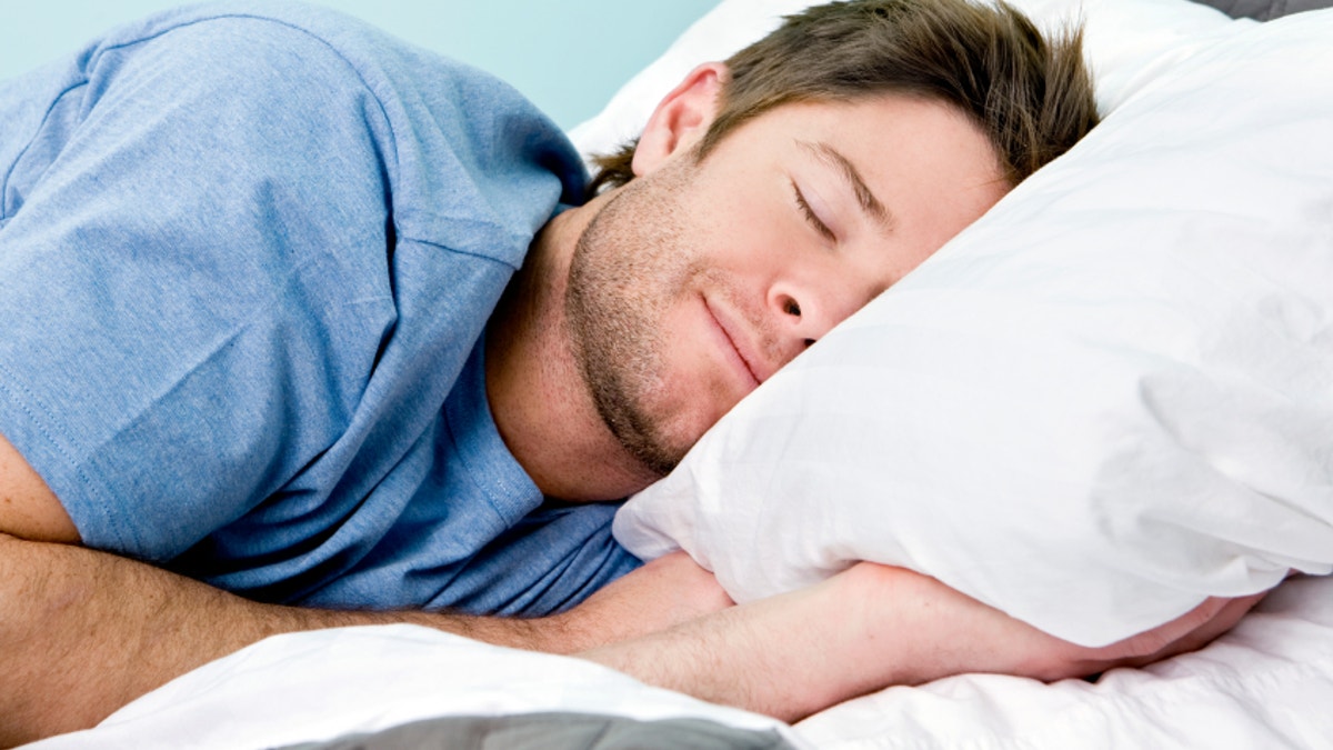 Man comfortably sleeping in his bed