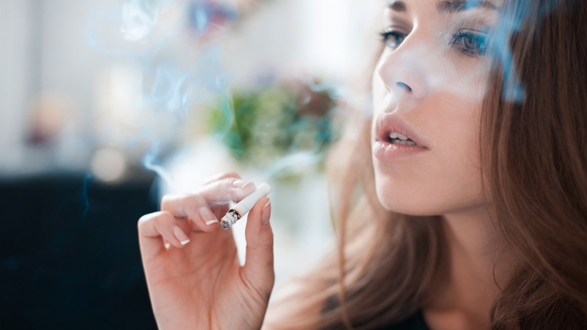 woman smoking a cigarette istock large