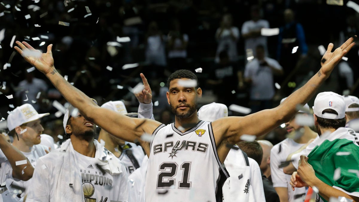 FILE - In this June 15, 2014, file photo, San Antonio Spurs forward Tim Duncan (21) celebrates after Game 5 of the NBA basketball finals in San Antonio. Duncan announced his retirement on Monday, July 11, 2016, after 19 seasons, five championships, two MVP awards and 15 All-Star appearances. It marks the end of an era for the Spurs and the NBA. (AP Photo/David J. Phillip, File)