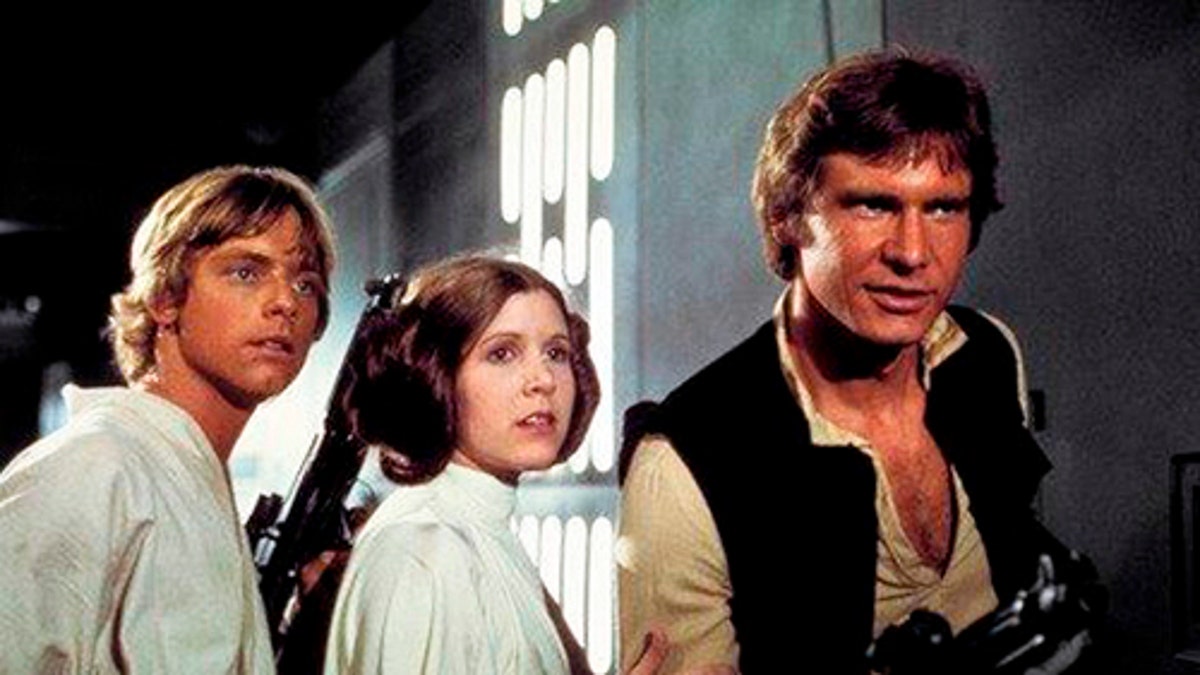 This photo provided by Twentieth Century Fox Home Entertainment shows, Mark Hamill, from left, as Luke Skywalker, Carrie Fisher as Princess Leia Organa, and Harrison Ford as Hans Solo in the original 1977 