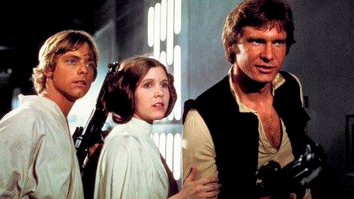 This photo provided by Twentieth Century Fox Home Entertainment shows, Mark Hamill, from left, as Luke Skywalker, Carrie Fisher as Princess Leia Organa, and Harrison Ford as Hans Solo in the original 1977 