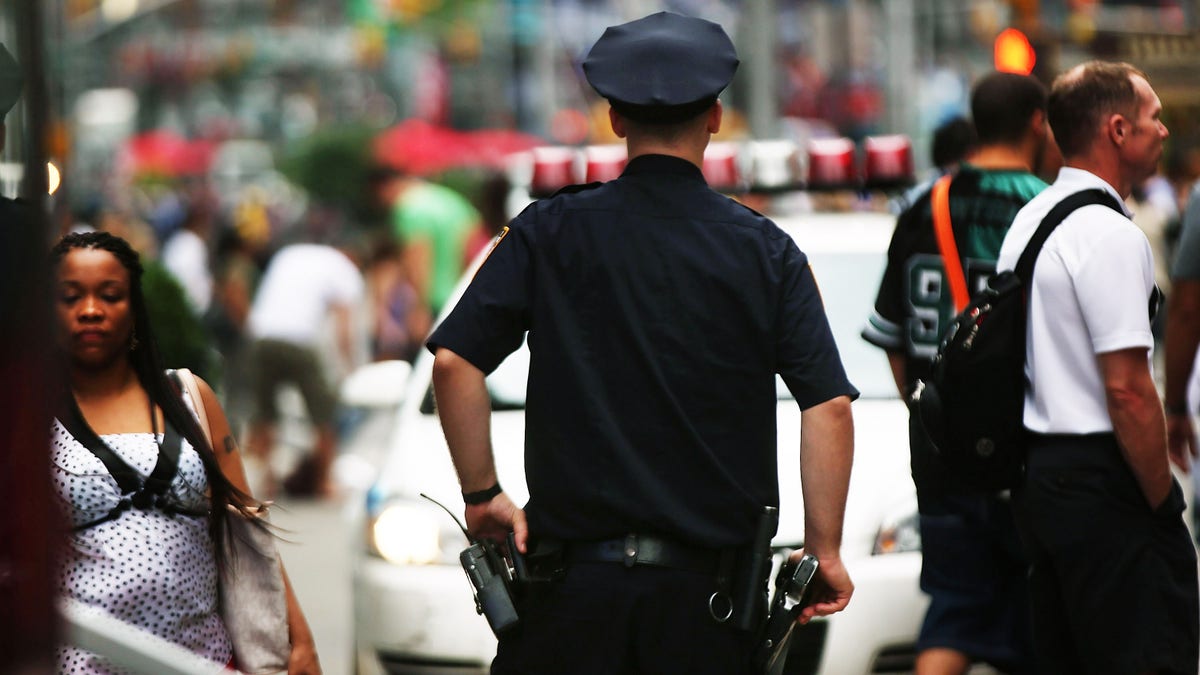 NEW YORK, NY - AUGUST 12: A New York City police officer stands in Times Square on August 12, 2013 in New York City. The controversial policy employed by the New York Police Department (NYPD) in high crime neighborhoods known as stop and frisk, has been given a severe rebuke by a federal judge on Monday. U.S. District Court Judge Shira Scheindlin has appointed an independent monitor to oversee changes to the NYPD's stop and frisk tactic's after finding that it intentionally discriminates based on race. Both New York City Mayor Michael Bloomberg and New York City Police Commissioner Raymond Kelly. (Photo by Spencer Platt/Getty Images)