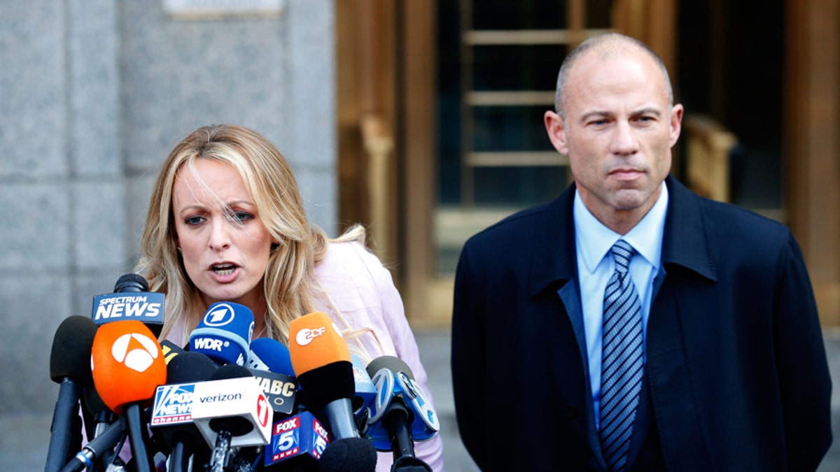 Adult film actress Stephanie Clifford, also known as Stormy Daniels, speaks to media along with lawyer Michael Avenatti (R) outside federal court in the Manhattan borough of New York City, New York, U.S., April 16, 2018. REUTERS/Brendan Mcdermid - HP1EE4G1MU9NV