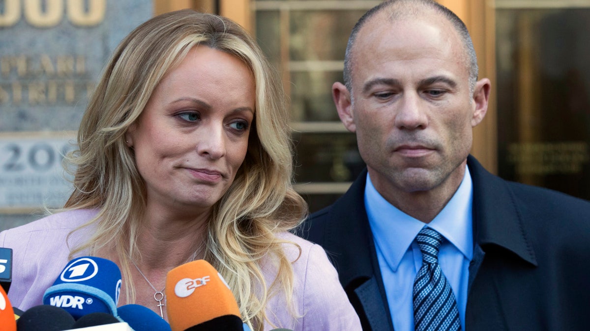 Adult film actress Stormy Daniels, left, stands with her lawyer Michael Avenatti as she speaks outside federal court, Monday, April 16, 2018, in New York. (AP Photo/Mary Altaffer)