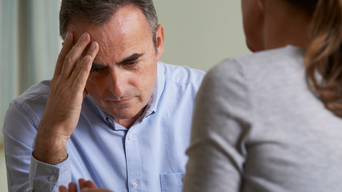 Man talking to adult child