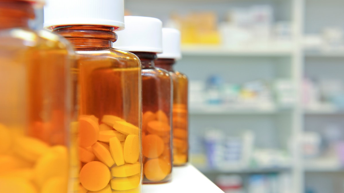 row of bottles and pills on a chemists counter