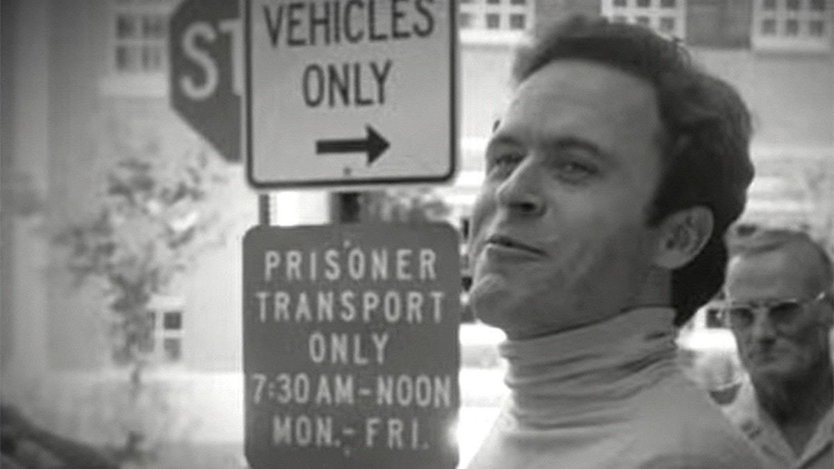 ted bundy standing before signs