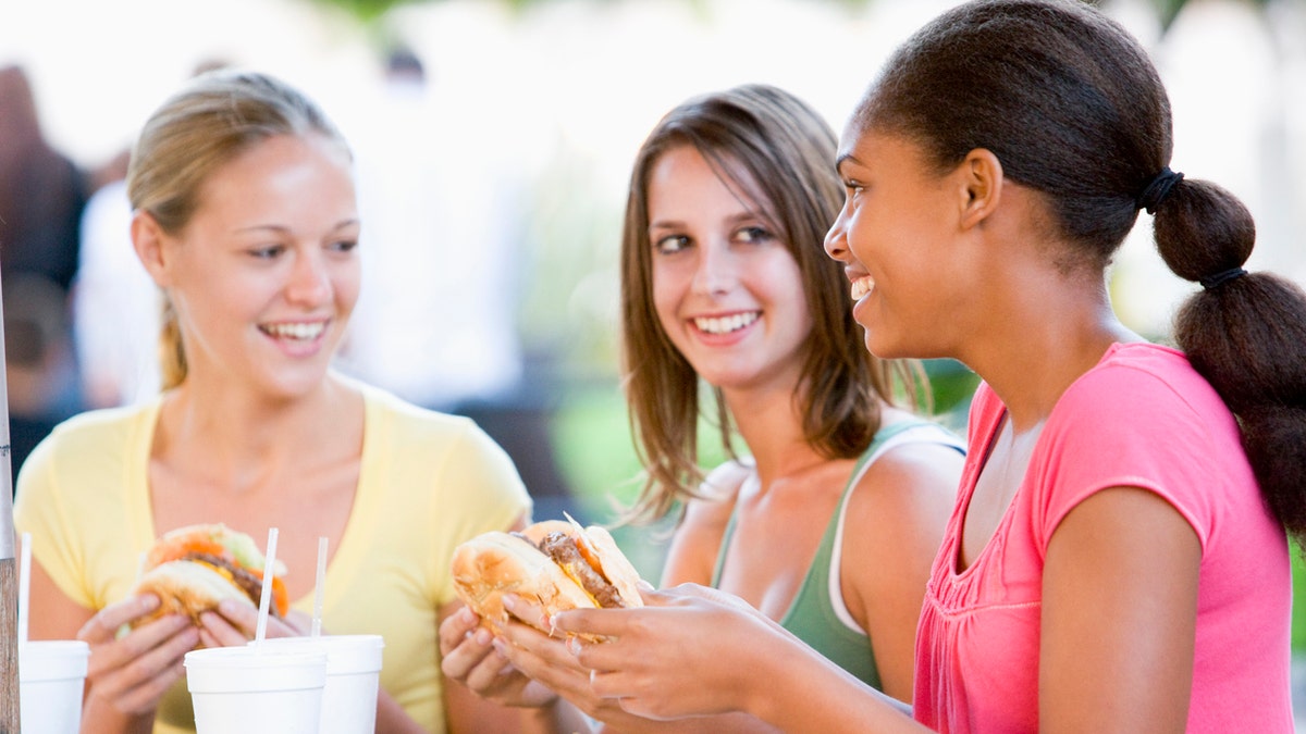 teen girls eating fast food istock medium