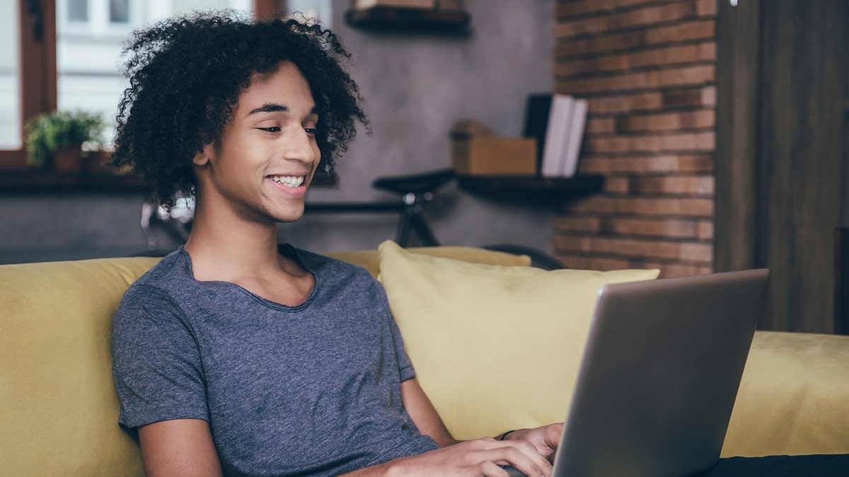 teen using laptop iStock