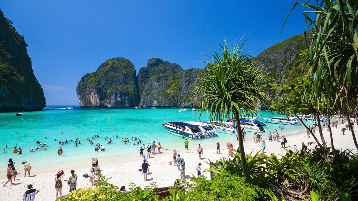 In this March 4, 2017, photo, tourists enjoy the popular Maya bay on Phi Phi island, Krabi province. Authorities have ordered the temporary closing of the beach made famous by the Leonardo DiCaprio movie 