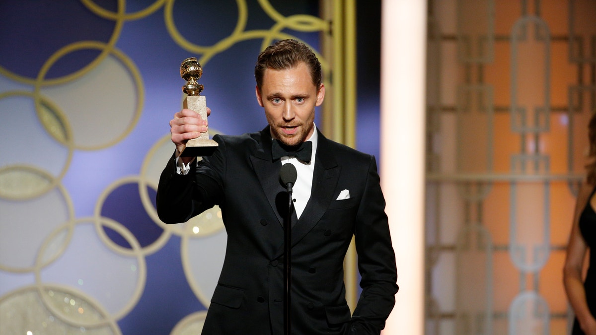 This image released by NBC shows Tom Hiddleston with the award for best actor in a limited series or TV movie for 