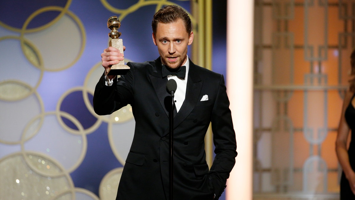 This image released by NBC shows Tom Hiddleston with the award for best actor in a limited series or TV movie for 