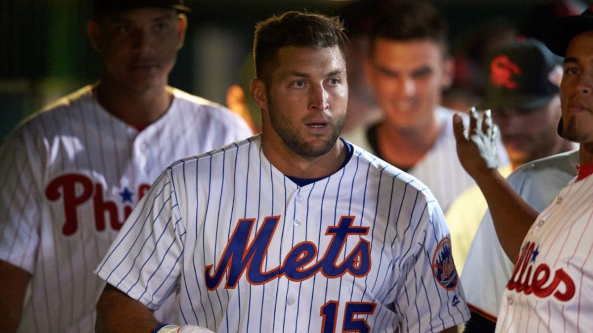 Scottsdale Scorpions left fielder Tim Tebow (15), of the New York Mets organization, in the dugout during a game against the Salt River Rafters on Oct. 12, 2016, at Scottsdale Stadium in Scottsdale, Arizona. Salt River defeated Scottsdale 6-4. (Mike Janes/Four Seam Images via AP)