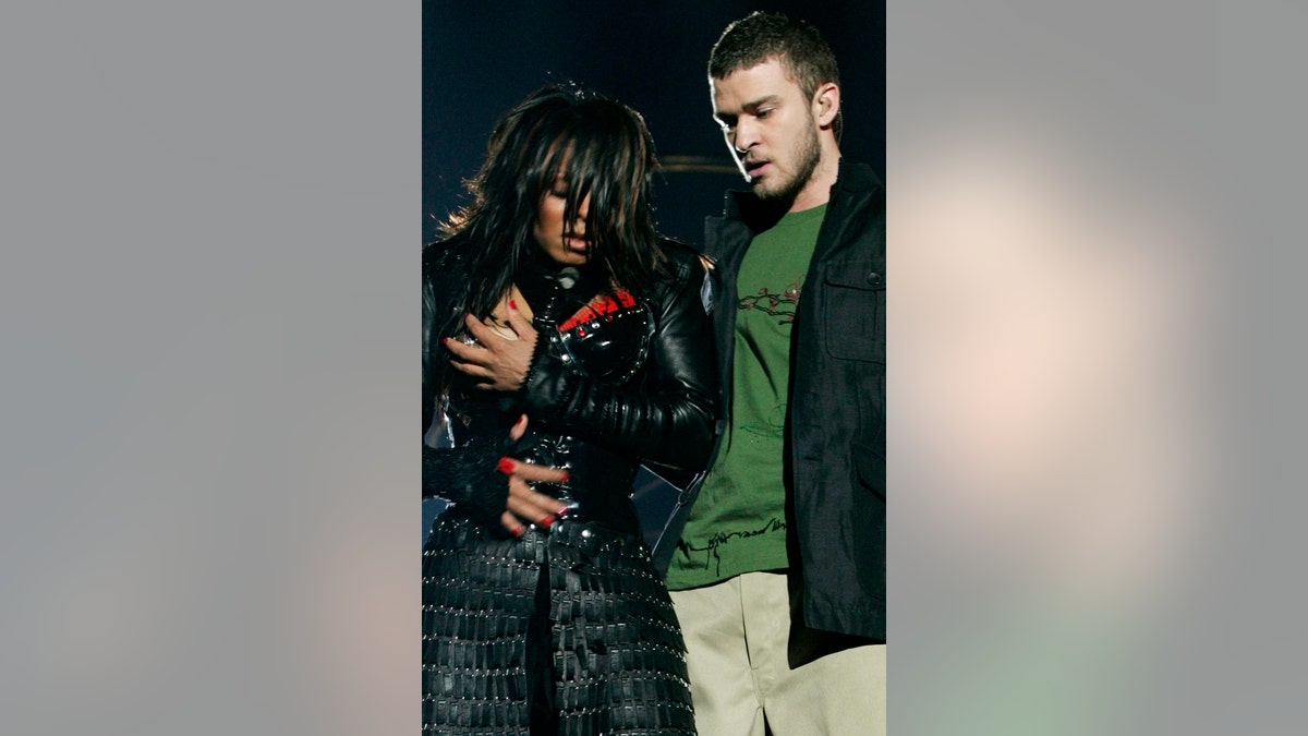 Janet Jackson (L) reacts after fellow singer Justin Timberlake ripped off one of her chest plates at the end of their half time performance at Super Bowl XXXVIII in Houston, February 1, 2004. Jackson turned heads on Sunday night during a half-time appearance with Timberlake during the Carolina Panthers-New England Patriots game, bumping and grinding through a duet. Just as the song came to its close, Timberlake reached for Jackson and tore part of her black leather bustier, revealing one breast. REUTERS/Win McNamee - RP4DRIBQZIAA