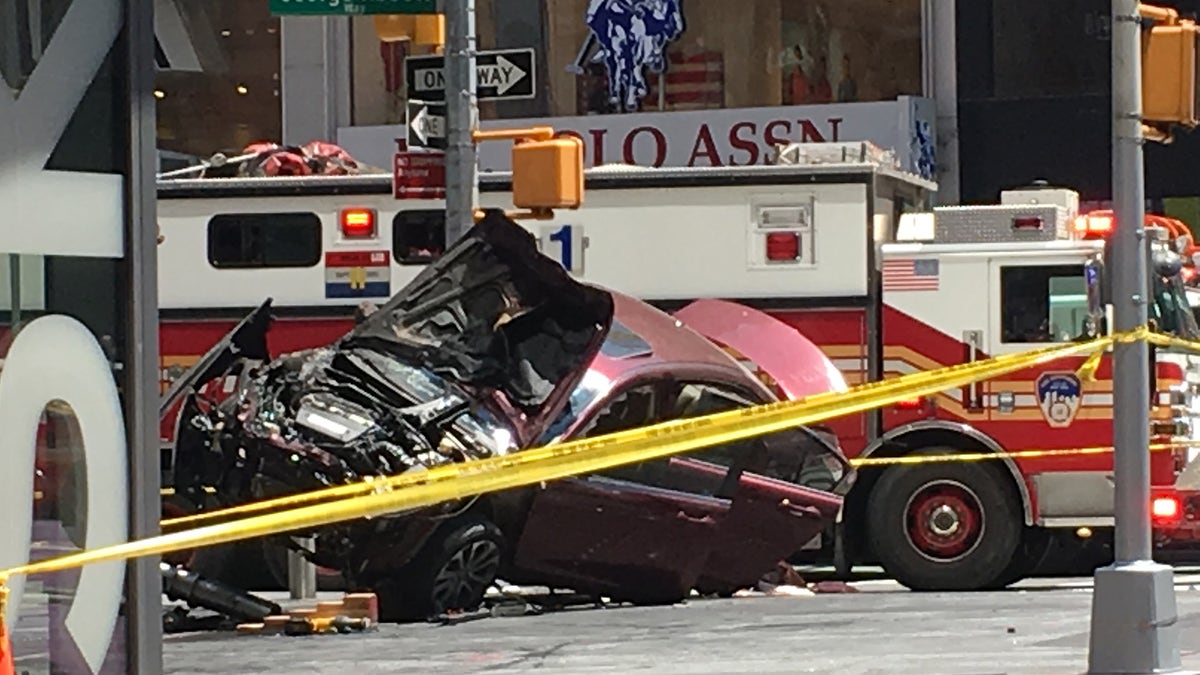 A smashed car sits on the corner of Broadway and 45th Street in New York's Times Square after driving through a crowd of pedestrians