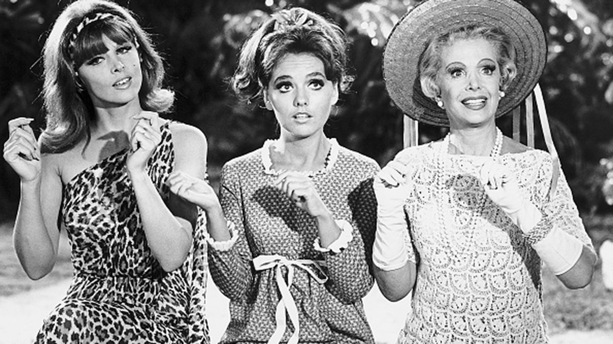 From left to right, sex-kitten Ginger (Tina Louise), girl-next-door Mary Ann (Dawn Wells), and millionairess Mrs. Howell (Natalie Schaefer) in a scene from the 1960s television comedy 