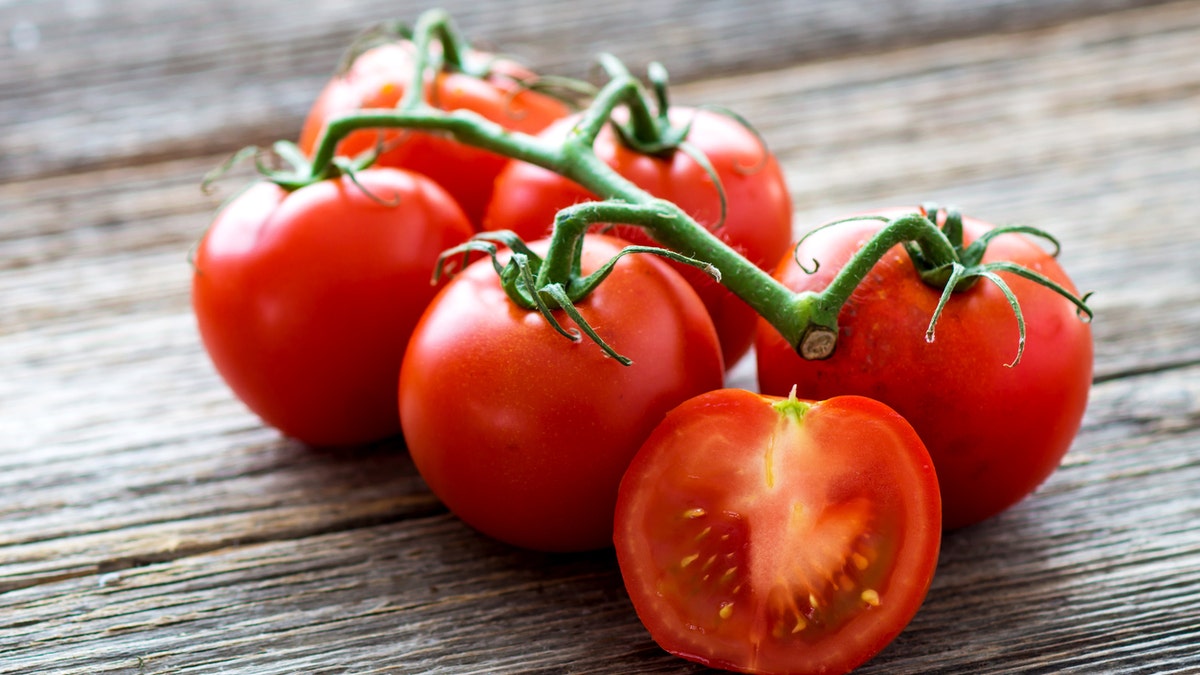 Fresh tomatoes on wood background