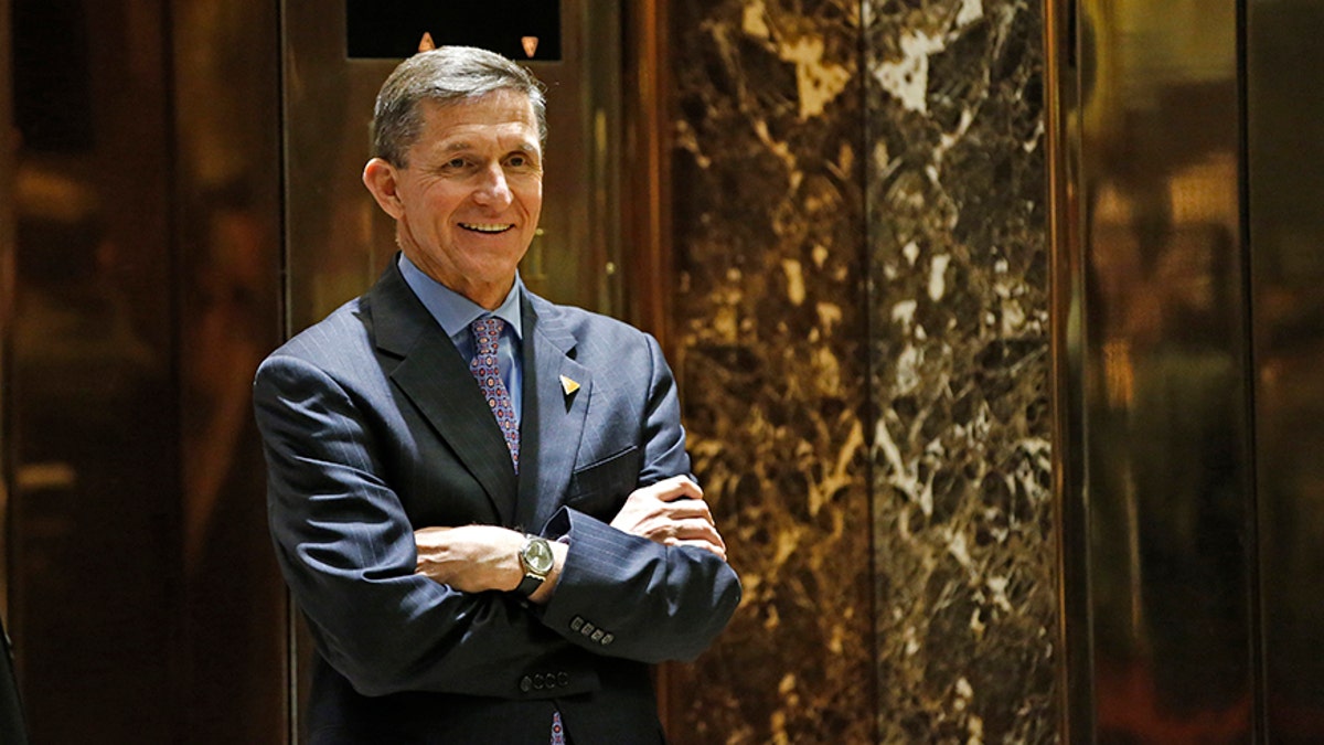 FILE - In this Dec. 12, 2106 file photo, National Security Advise-designate Michael T. Flynn, waits for an elevator at Trump Tower in New York. Propelled by populist energy, President-elect Donald Trumpâs candidacy broke long-standing conventions and his incoming Cabinet embodies a sharp turn from the outgoing Obama administration.  (AP Photo/Kathy Willens, File)