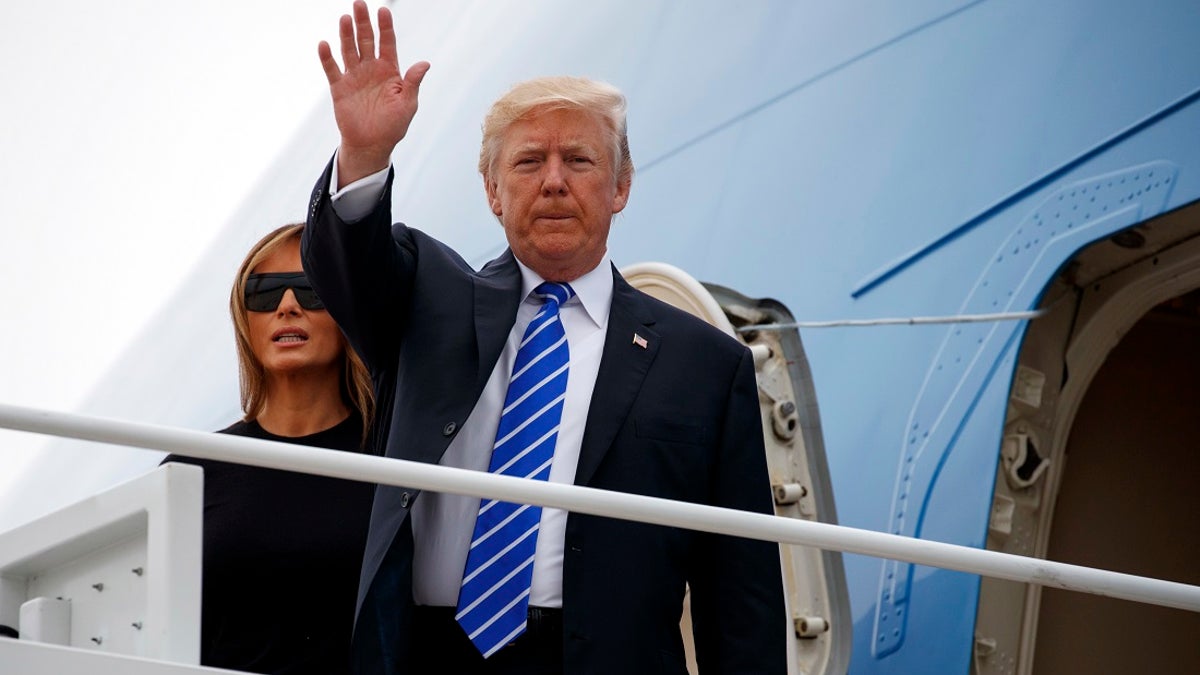 President Donald Trump waves as he boards Air Force One with first lady Melania Trump for a trip to Poland and Germany, Wednesday, July 5, 2017, at Andrews Air Force Base, Md. (AP Photo/Evan Vucci)