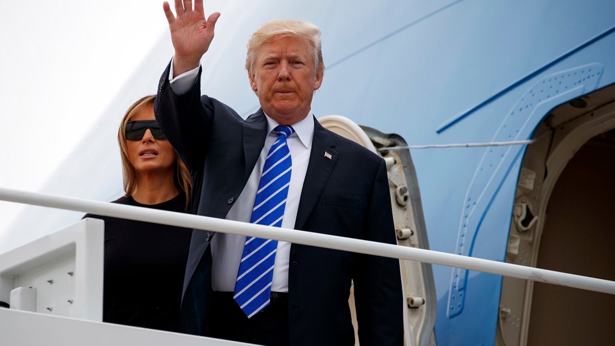 President Donald Trump waves as he boards Air Force One with first lady Melania Trump for a trip to Poland and Germany, Wednesday, July 5, 2017, at Andrews Air Force Base, Md. (AP Photo/Evan Vucci)