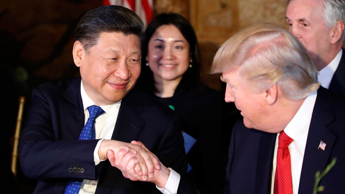 In this April 6, 2017 file photo, President Donald Trump, right, shakes hands with Chinese President Xi Jinping during a dinner at Mar-a-Lago, in Palm Beach, Fla.