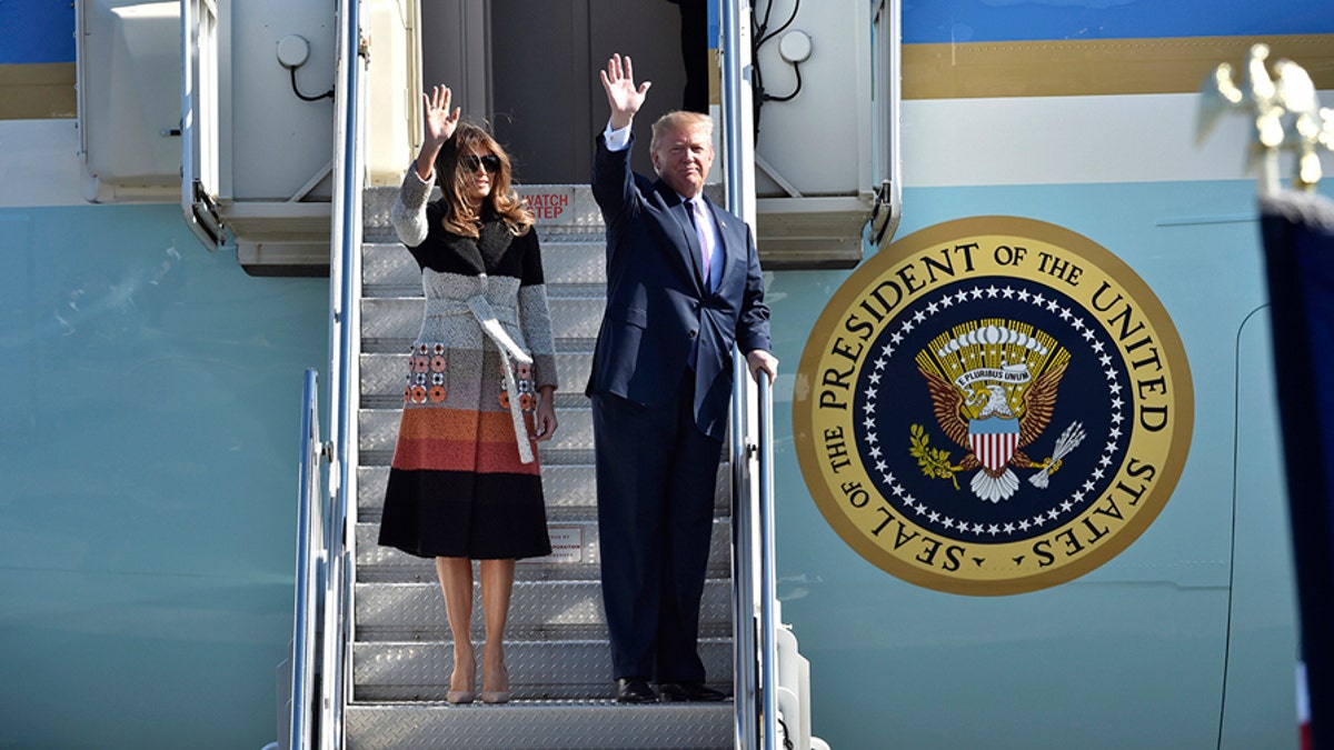 U.S. President Donald Trump, right, and first lady Melania Trump, left, wave on their arrival at the U.S. Yokota Air Base, on the outskirts of Tokyo, Sunday, Nov. 5, 2017. President Trump arrived in Japan Sunday on a five-nation trip to Asia, his second extended foreign trip since taking office and his first to Asia. The trip will take him to Japan, South Korea, China, Vietnam and Philippines for summits of the Asia-Pacific Economic Cooperation (APEC) and the Association of Southeast Asian Nations (ASEAN). (Kazuhiro Nogi/Pool Photo via AP)