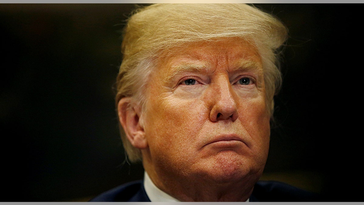 U.S. President Donald Trump listens during a round table meeting with members of law enforcement about sanctuary cities in the Roosevelt Room at the White House in Washington, U.S., March 20, 2018. REUTERS/Leah Millis - RC15C0656120