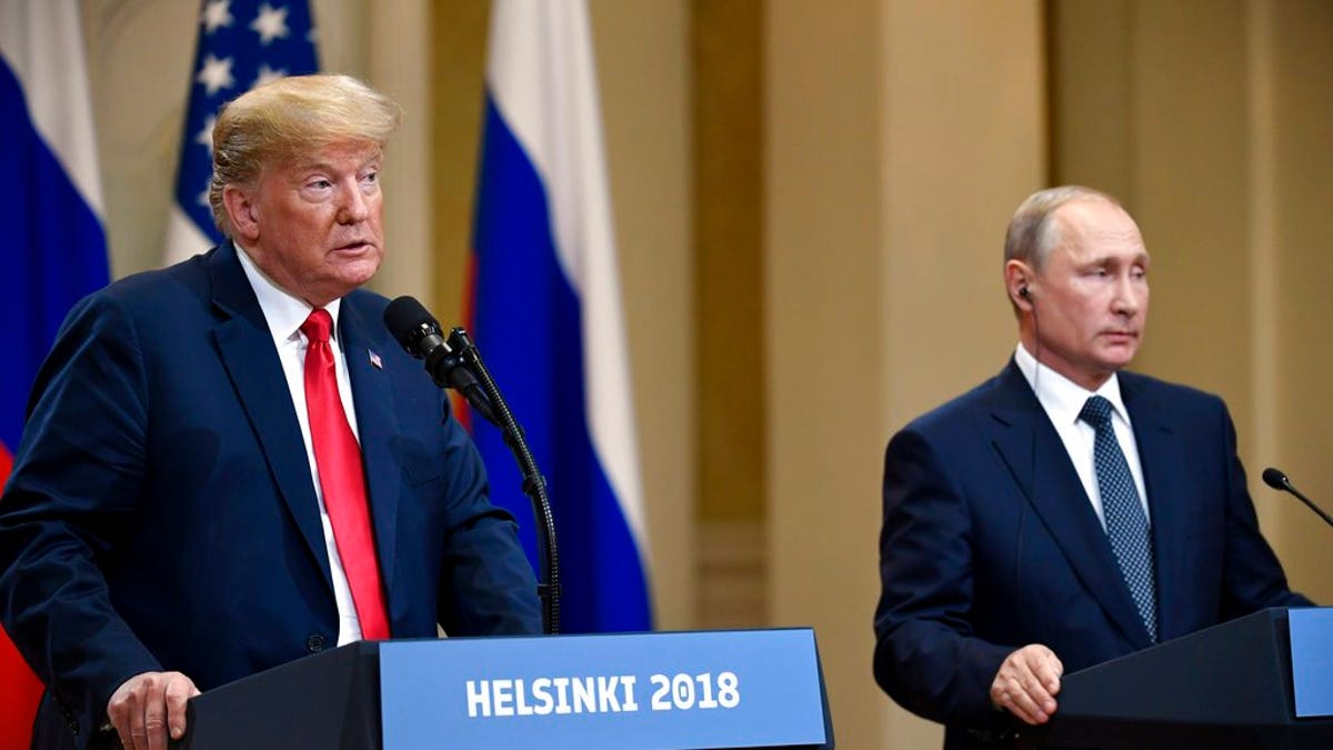 U.S. President Donald Trump speaks as Russian President Vladimir Putin listens during a join press conference at the Presidential Palace in Helsinki, Finland, Monday, July 16, 2018. (Antti Aimo-Koivisto/Lehtikuva via AP)