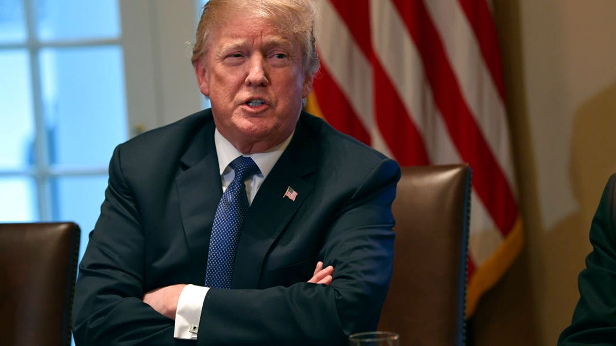 President Donald Trump speaks in the Cabinet Room of the White House in Washington, Monday, April 9, 2018, at the start of a meeting with military leaders. Federal agents raided the office of Trump's personal attorney Michael Cohen, seizing records on topics including a $130,000 payment made to a porn actress who says she had sex with Trump more than a decade ago. The move ignited the president's anger, with Trump calling it a "disgrace" that federal agents "broke into" the office of his personal attorney. He also called special counsel Robert Mueller's investigation "an attack on our country." (AP Photo/Susan Walsh)