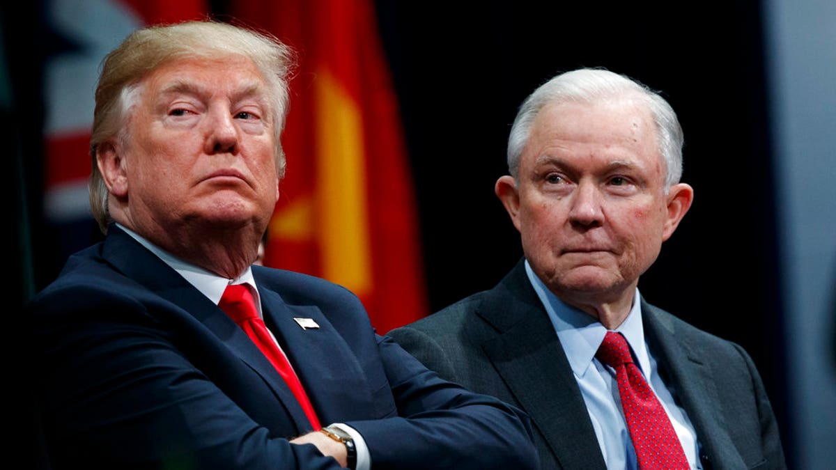 FILE - In this Dec. 15, 2017 file photo, President Donald Trump, left, sits with Attorney General Jeff Sessions during the FBI National Academy graduation ceremony in Quantico, Va. The Trump administration on Tuesday, Jan. 16, 2018, appealed a judge's ruling temporarily blocking its decision to end protections for hundreds of thousands of young immigrants and announced plans to seek U.S. Supreme Court review even before the appeals court issues a decision. Sessions said in a statement that it defied 