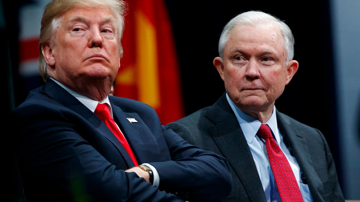 FILE - In this Dec. 15, 2017 file photo, President Donald Trump, left, sits with Attorney General Jeff Sessions during the FBI National Academy graduation ceremony in Quantico, Va. The Trump administration on Tuesday, Jan. 16, 2018, appealed a judge's ruling temporarily blocking its decision to end protections for hundreds of thousands of young immigrants and announced plans to seek U.S. Supreme Court review even before the appeals court issues a decision. Sessions said in a statement that it defied 