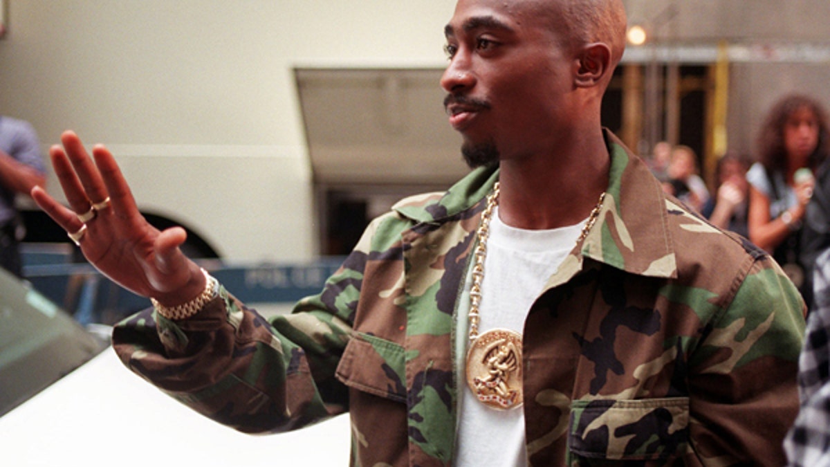 FILE- In this Sept. 4, 1996 file photo, Rapper Tupac Shakur arrives at New York's Radio City Music Hall for the 13th Annual MTV Video Music Awards. A New York judge has stopped on Tuesday, July 18, 2017, an impending auction of pop star Madonna's personal items, including a love letter from Shakur, her former boyfriend. (AP Photo/Todd Plitt, File)