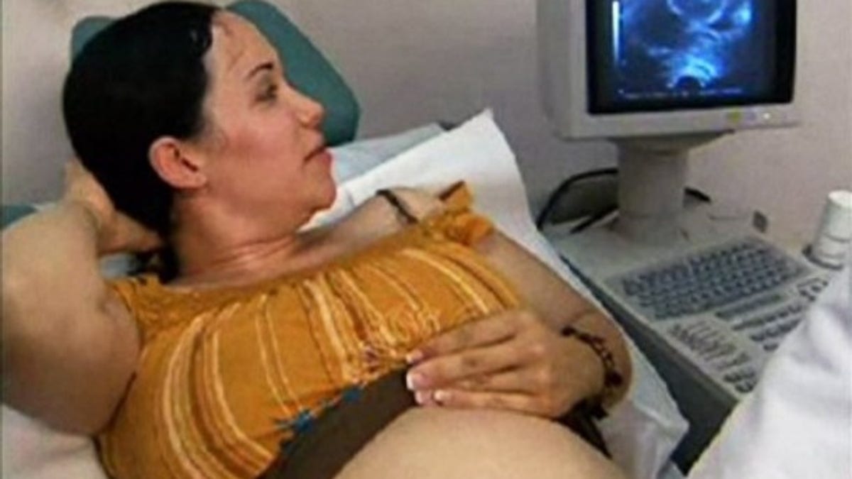 FILE - This image made from a 2006 video provided by KTLA shows Nadya Suleman looking at a ultrasound of her unborn twins at an in-vitro fertilization clinic in Los Angeles