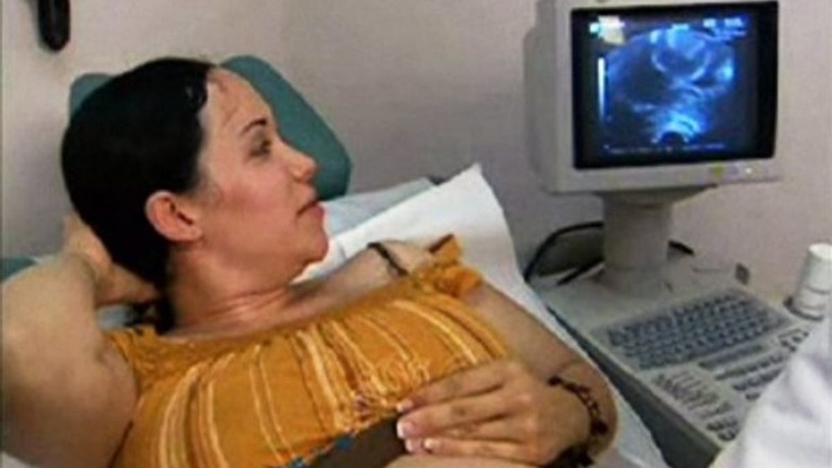 FILE - This image made from a 2006 video provided by KTLA shows Nadya Suleman looking at a ultrasound of her unborn twins at an in-vitro fertilization clinic in Los Angeles