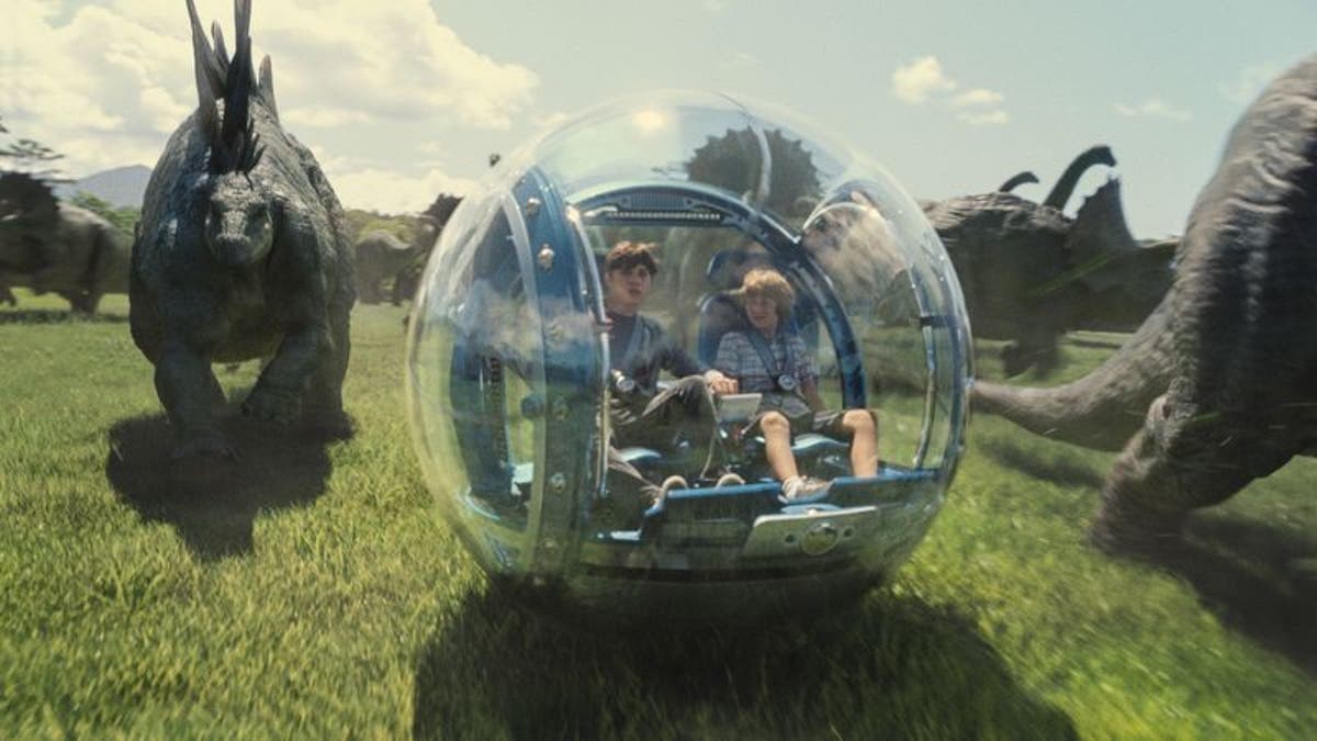 'Jurassic World' park visitors ride alongside dinosaurs in glass spheres. 