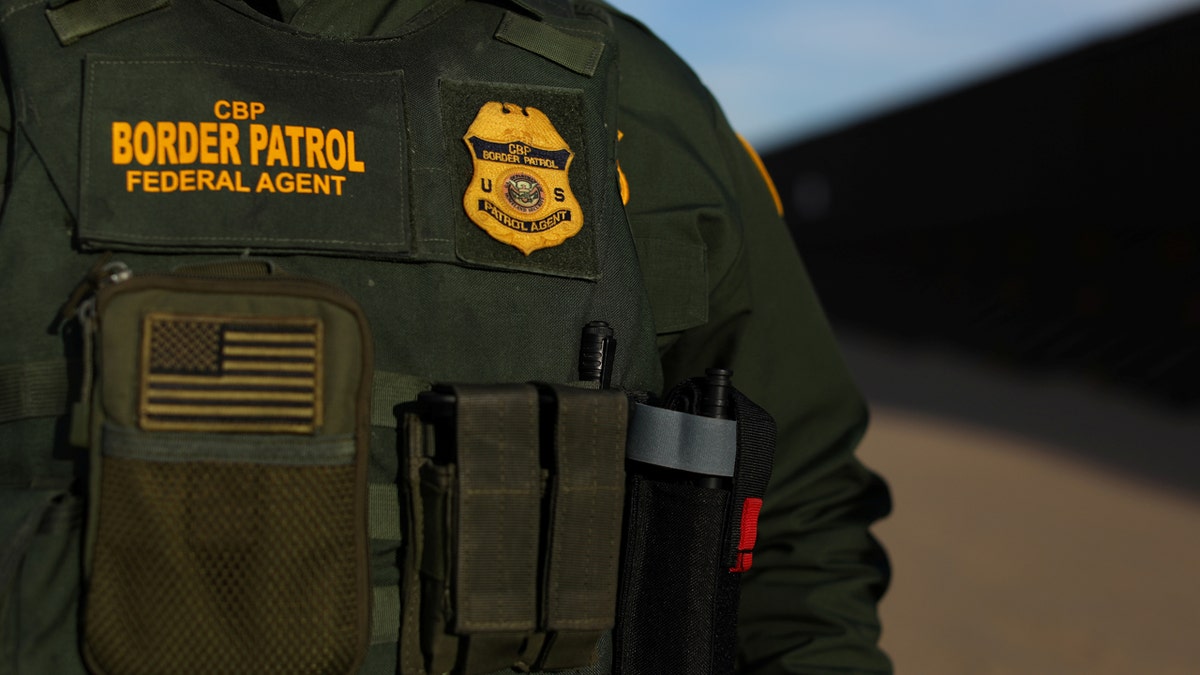 U.S. border patrol agent Alessio Faccin walks along the border fence separating Mexico from the United States near Calexico, California, U.S. February 8, 2017. Picture taken February 8, 2017. REUTERS/Mike Blake - RC166A17F9D0