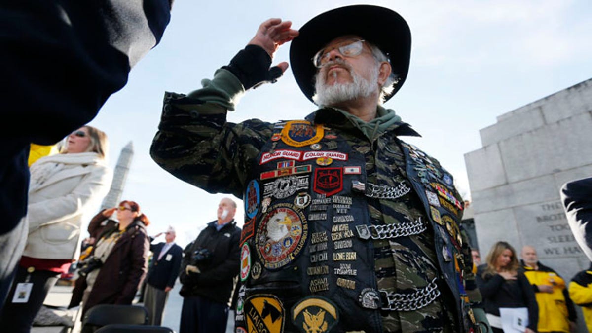 Vietnam veteran Paul Troop, honors his fallen comrades while at the World War II Memorial on Veterans Day in Washington, Nov. 11, 2013.