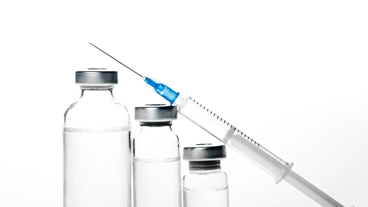 vials and a syringe istock