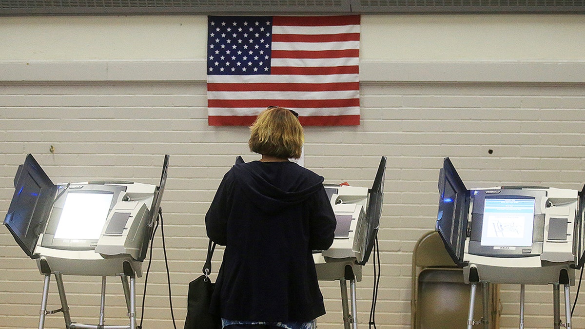 Virginia Cronin casts her ballot during the primary election on Tuesday, Aug. 21, 2018, at the Laramie County School District 1 Administration Building in Laramie, Wyo. (Blaine McCartney/The Wyoming Tribune Eagle via AP)