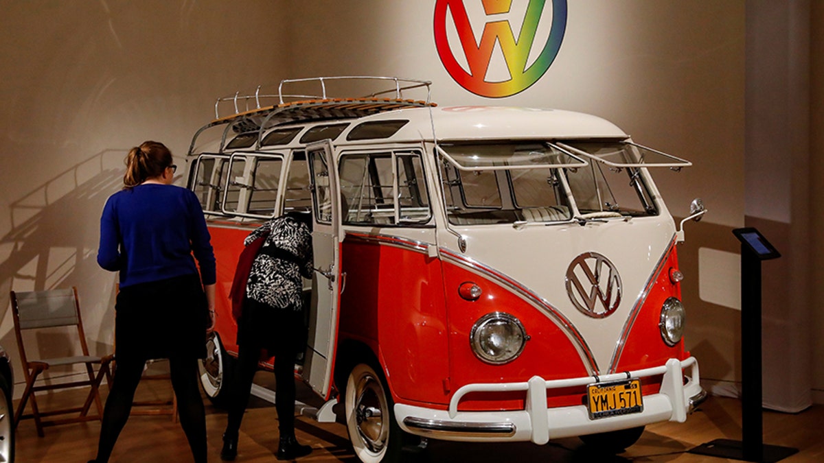 Guests looks at a 1960 Volkswagen Deluxe "23-Window" Microbus displayed during a media preview for the "RM Sotheby's Icons" sale at Sotheby's in New York, U.S., November 30, 2017. REUTERS/Brendan McDermid - RC11E8BBA980