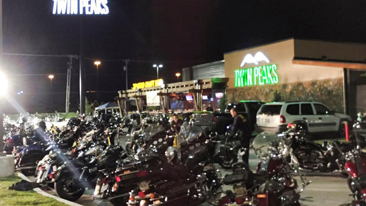 Waco Police Department photo shows police investigators at the scene at the Twin Peaks Restaurant in Waco, Texas in this images released on May 18, 2015. Police in Waco, Texas said 192 people were being arrested on Monday in connection with a biker gang shootout that left nine dead and 18 injured a day earlier.  REUTERS/Waco Police Department/Handout  FOR EDITORIAL USE ONLY. NOT FOR SALE FOR MARKETING OR ADVERTISING CAMPAIGNS. THIS IMAGE HAS BEEN SUPPLIED BY A THIRD PARTY. IT IS DISTRIBUTED, EXACTLY AS RECEIVED BY REUTERS, AS A SERVICE TO CLIENTS - TM3EB5I0QSY01