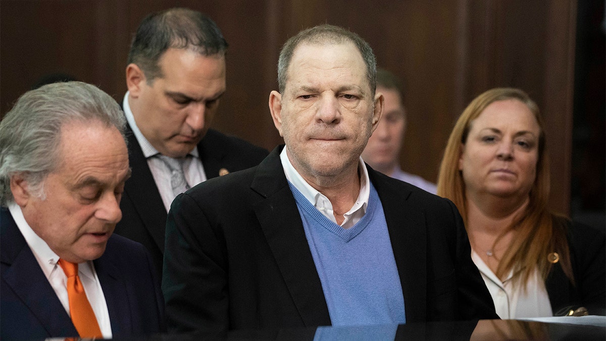 FILE - In this May 25, 2018 file photo, Harvey Weinstein, center, listens during a court proceeding in New York during his arraignment on rape and other charges. On Friday, June 1, 2018, a new rape allegation was made against Weinstein as part of a lawsuit alleging he had help covering up his misconduct with women. Melissa Thompson says that when she was meeting with Weinstein in 2011 to pitch internet technology, he cornered her and "out-muscled" her as she tried to fight him off. (Steven Hirsch/New York Post via AP, Pool)